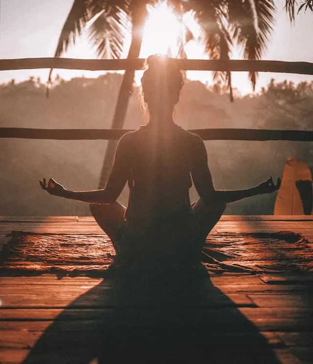 Morning yoga session on a deck facing the valley